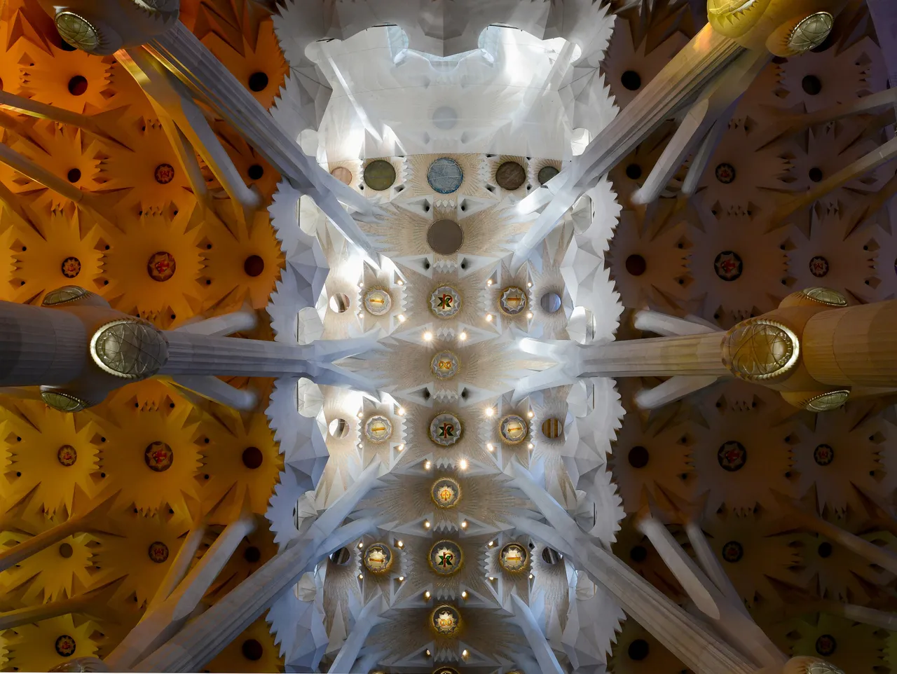 Looking up at the coloured-glass ceiling of the Sagrada Família