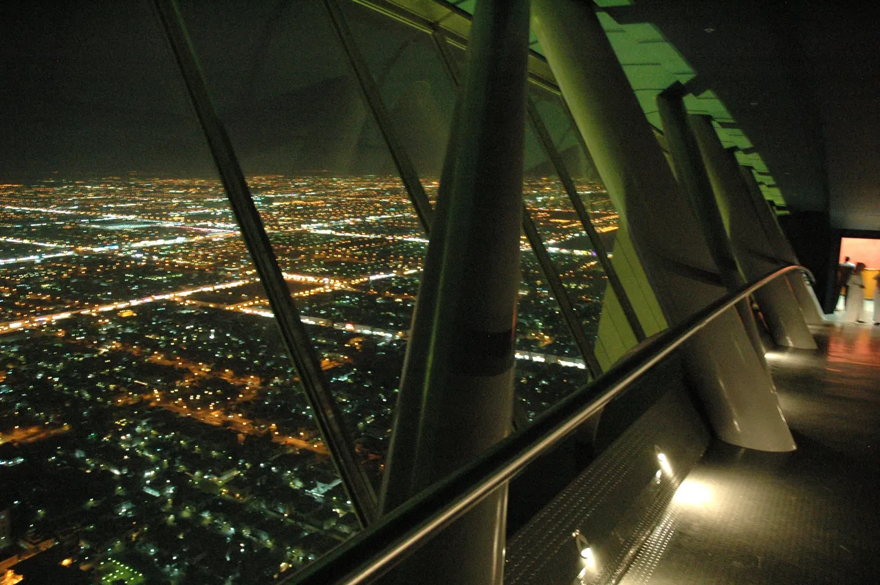 Riyadh's city lights at night seen through the Kingdom Centre skybridge